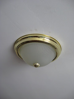 image of standard brass ceiling fixture that looks like a woman's breast