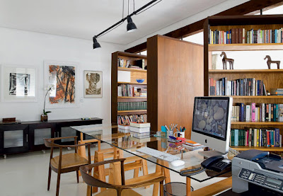 home office with library, textures wood cabinets and glass table