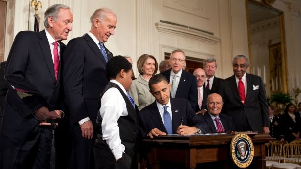 Obama+signing+the+health+care+bill