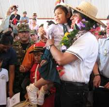 El presidente Morales carga en sus manos a la primera niña que recibió el bono. Foto:ABI
