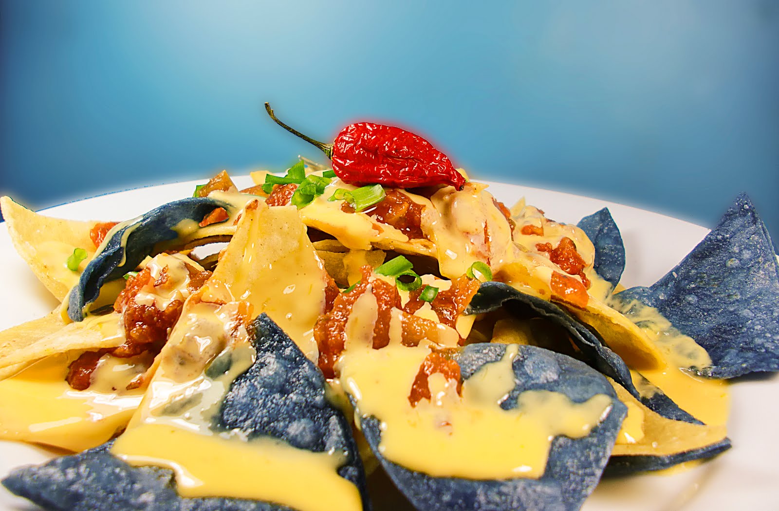 ChezWhat? nachos with blue and yellow corn chips