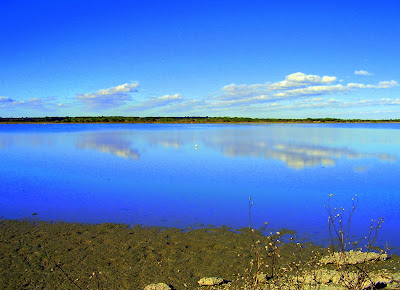 clouds reflected in the water on a sunny day