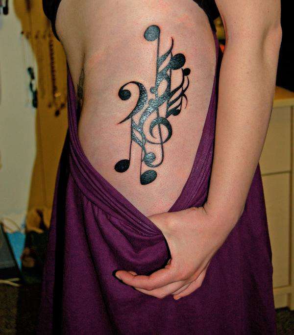 rib tattoos for girls. music tattoos for girls.