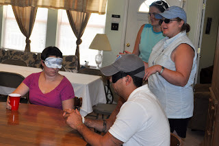 two guide dog instructors stand by our table where there is 5 of us blindfolded, well darrell isn't but the rest of us are