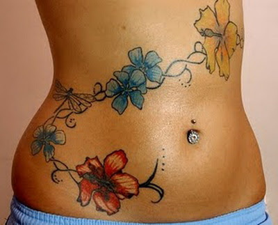 Body Piercing and tattoo on female stomach