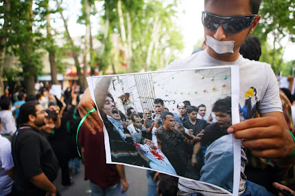 Man holds a picture of his murdered friend