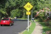 The second of seven eastbound 'Share the Road' signs on Killarney Way.
