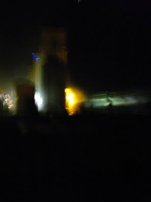 Loading grain cars at night. Photo by Chas S. Clifton