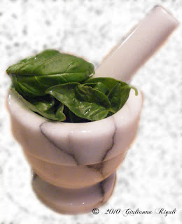 Organic Basil Leaves in a Mortar with Pestle