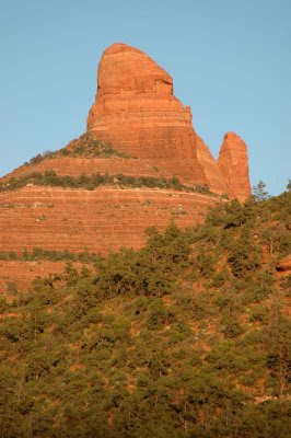 a red-rock mountain towers over the Sedona valley