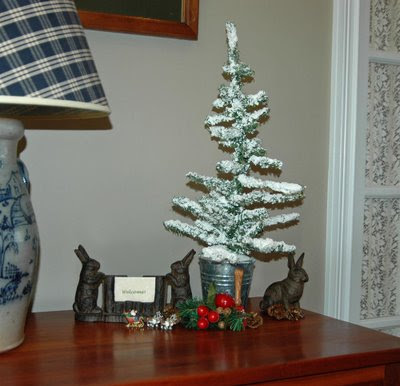 rabbit greeters and a snowy tree stand watch near the front door