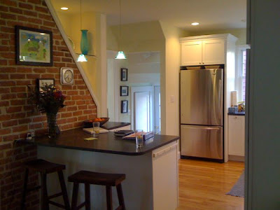 Kitchen after remodeling with two Pyramid pendant lights make the room seem taller