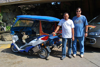 Willy Dela Cruz of Eagle Motorcycles and Dave Dewbre EVC,with the 3000 watt electric motorcycle retrofitted onto an old existing gas tricycle cab.
