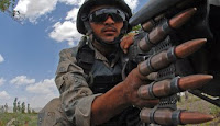 An Afghan border policeman scans his sector in Paktika province, Afghanistan, last month.