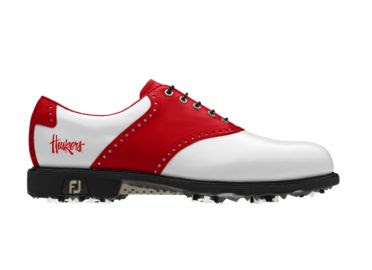 Red and white Nebraska golf shoe in classic design with the Huskers logo written across the back of this FJ piece of golf footwear that has black shoelaces and a rubber sole.