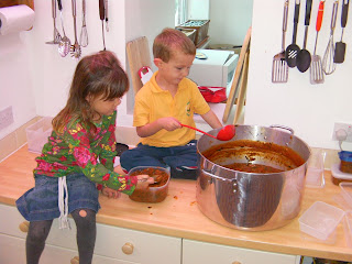serving out a cauldron of tomato soup
