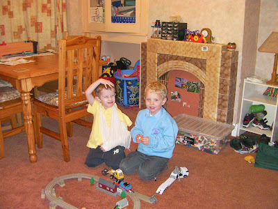 schoolboys playing lego and wooden train track from tesco
