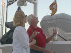 Hoisting the gold burgee after many, many miles of Looping!