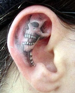 extreme ear tattoo with a skull image
