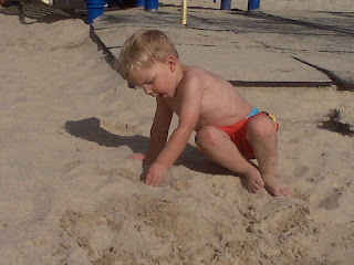 little boy playing in the sand