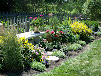 row of flowers along garden fence