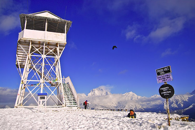 I'm Laying down on the snow with Poonhill Tower