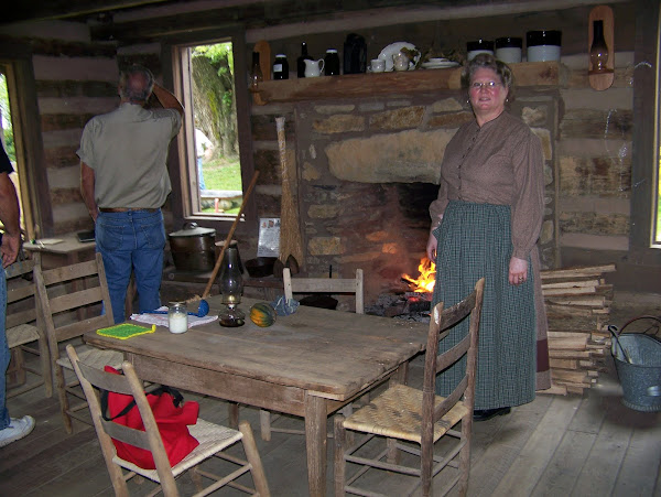 Cindy tells the history of the Payne Cabin and cooks in the fireplace