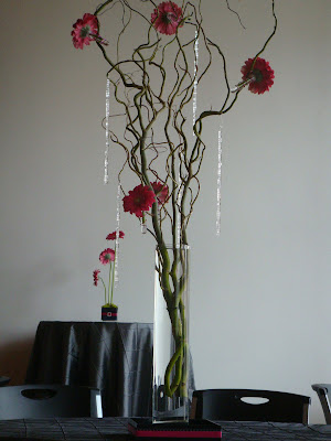 Centerpieces of curly willow branches with gerber daisies crystals 