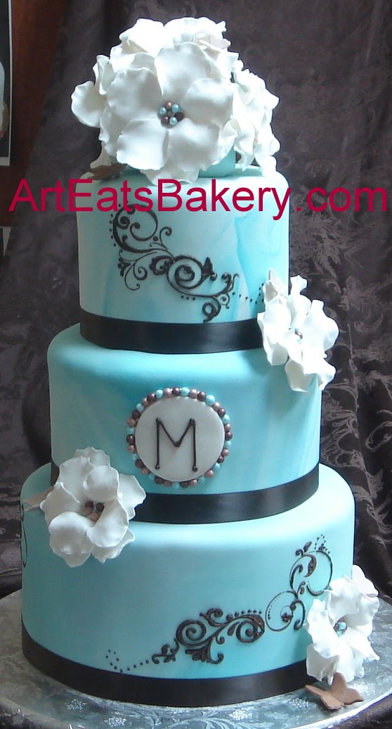 Blue marbled fondant round wedding cake with brown scroll work monogram Blue marbled fondant round wedding cake with brown scroll work monogram