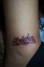My name in ink on her