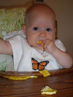 Baby eating eggs