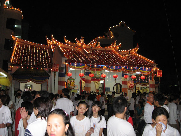 Buddhist devotees gather round the temple after the procession