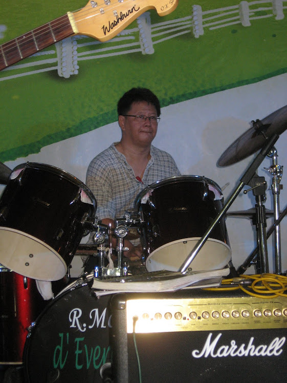 Mr Oh Kim Huat playing the drums