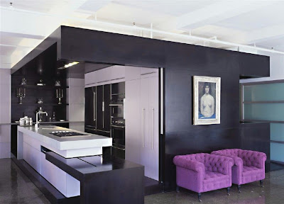 The kitchen is functional, done up in black and chrome