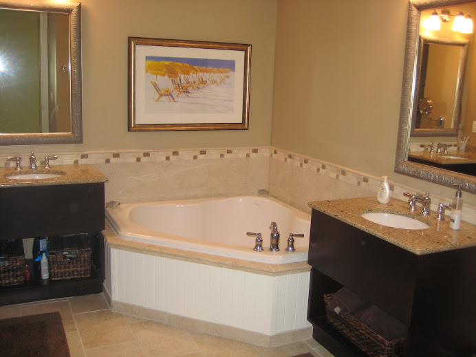 Large Bathroom with dual sinks and jetted tub.