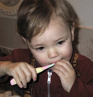 NAMC montessori education work and play girl brushing teeth