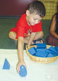 NAMC montessori parenting full time or part time preschool boy playing with geometric solids