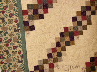 Jelly Roll quilt with Moda fabrics, quilted by Angela Huffman