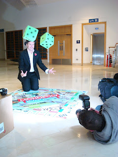 tossing dice to launch the Belfast edition of Monopoly