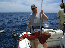 Troy with a squid he caught in Cabo