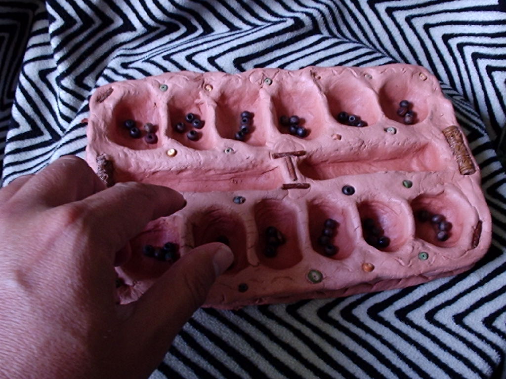 [mancala+with+hand.jpg]