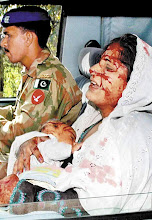 WOUNDED WOMAN WITH HER CHILD MULTAN PAKISTAN