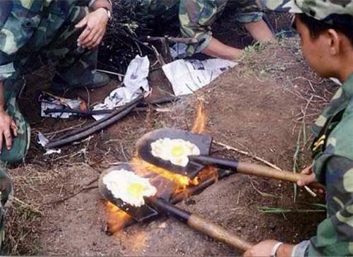Militares haciendo huevos fritos en una pala
