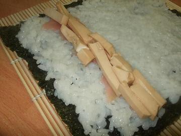 Laying out the sushi contents on the rice and nori