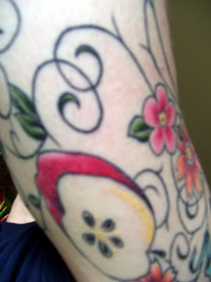 Random Guy with Apple Tattoo behind. The backside of my arm has a cut apple, 
