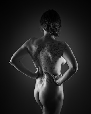 This model had an interesting tattoo on her back This model had an interesting tattoo on her back