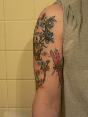 Red wings dragonfly tattoo with flowers tree.