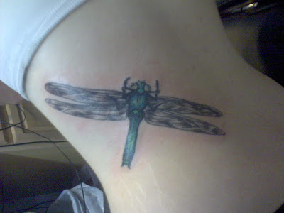 Big dragonfly tattoo on side lower back.