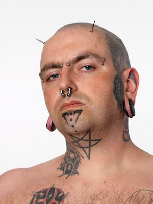 Basic star tattoo on man's front neck.