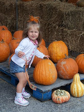 Ally trying to pick up her pumpkin....